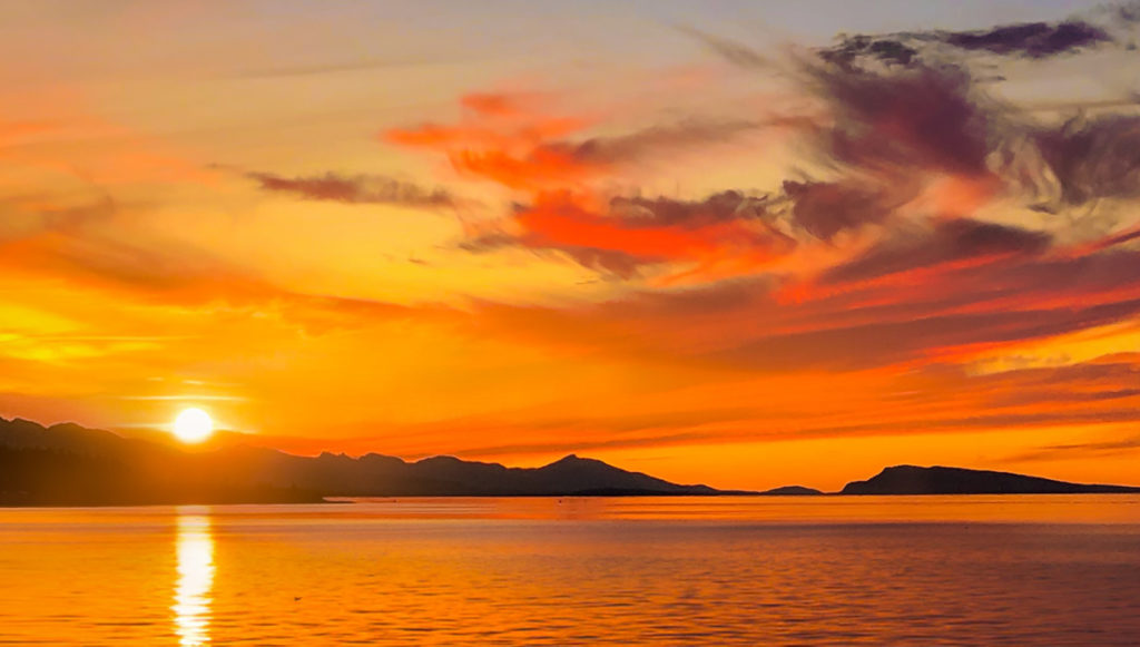 Landscape photo of the sun setting over a body of water