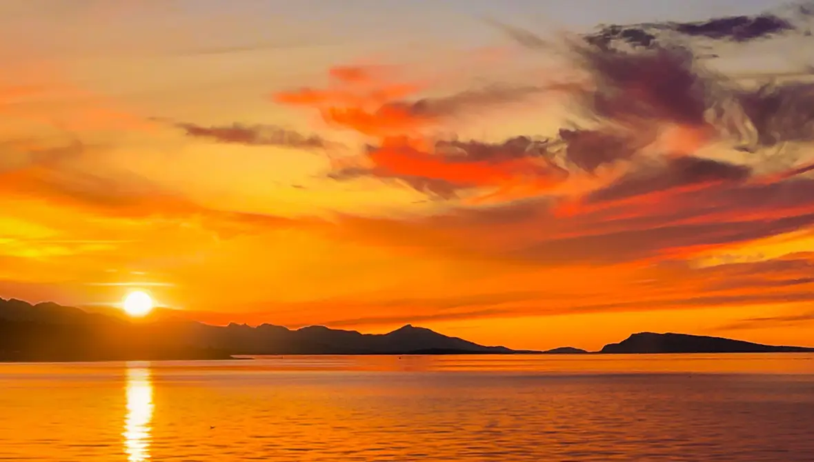 Landscape photo of the sun setting over a body of water
