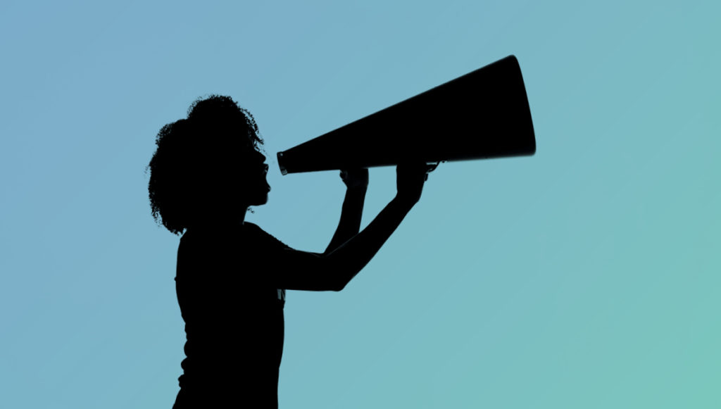 Silhouette of a woman shouting into a megaphone