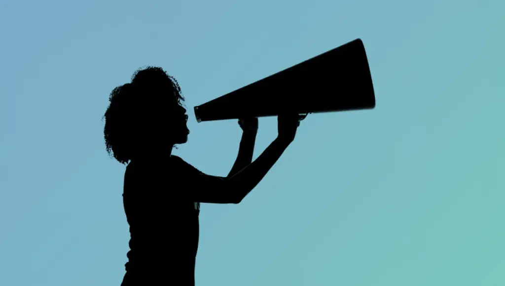 Silhouette of a woman shouting into a megaphone