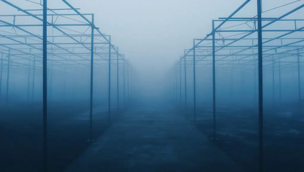 Photo of metal framing structures on a foggy day