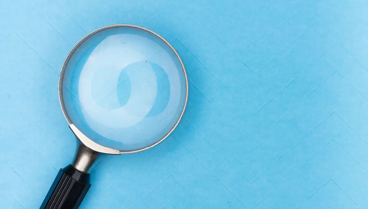 Photo of a magnifying glass on a blue background