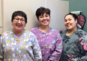 Photo of Aurora Johnson with dental assistants Deborah Ivanoff and Jerilyn Alakayak.