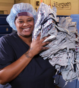 Photo of a smiling, African American female employee of Evergreen Cooperatives
