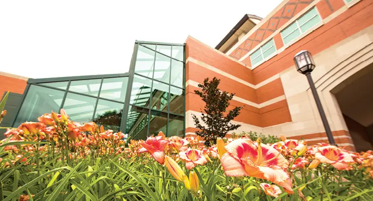 Photo: Spring flowers bloom in front of Henry Hall on Grand Valley State University’s Allendale, Mich. campus. Photographer: Amanda Pitts