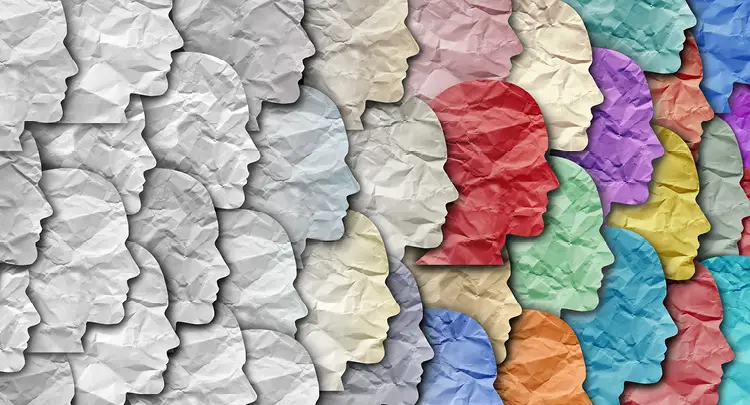 Image of many facial silhouettes overlapping, moving from all white on the left to more colorful silhouettes on the right