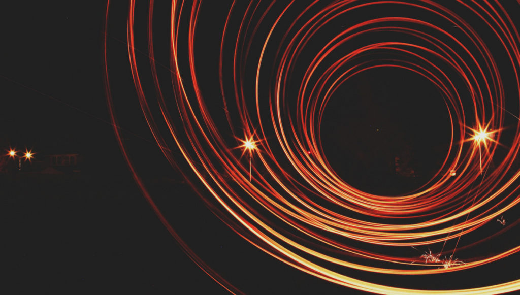 Abstract photo showing swirls of light on a dark background