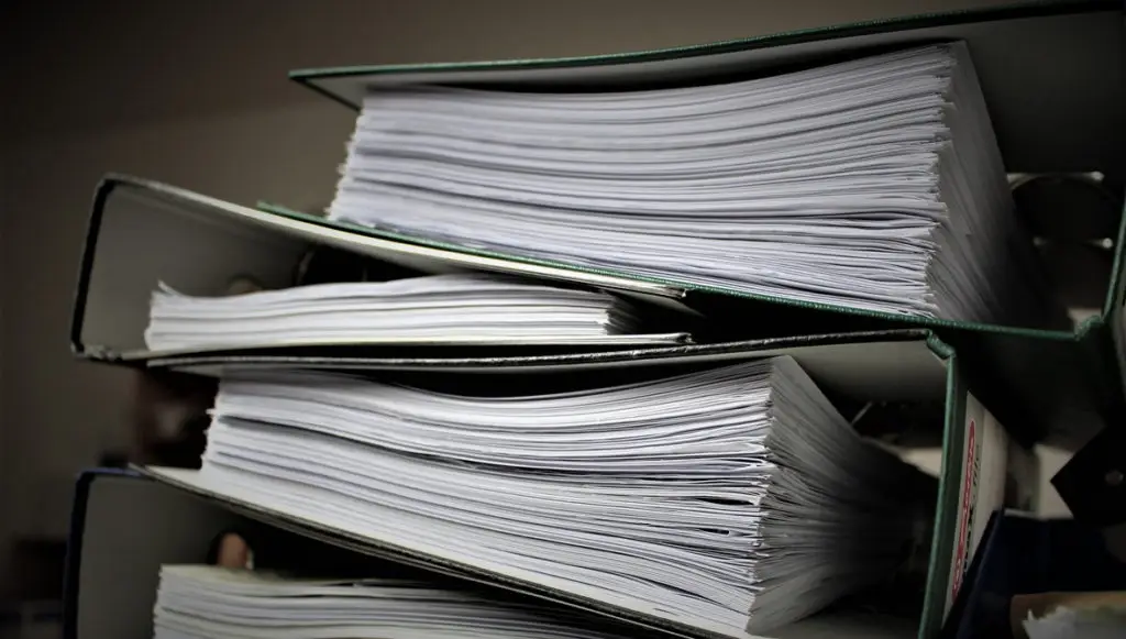 Photo of a stack of large three-ring binders full of papers, representing the idea of foundation archives