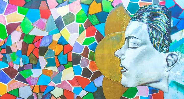 Photo of an outdoor, colorful mosaic mural.