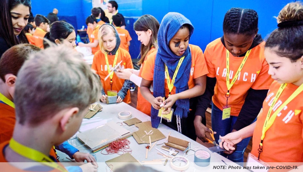 Photo of a group of students working on crafts at a table. NOTE: Photo was taken pre-COVID-19 (courtesy of Bosch Community Fund)