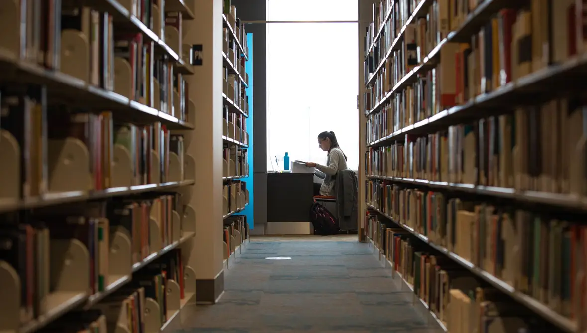 Photo of two large bookshelves inside a library at Grand Valley State University
