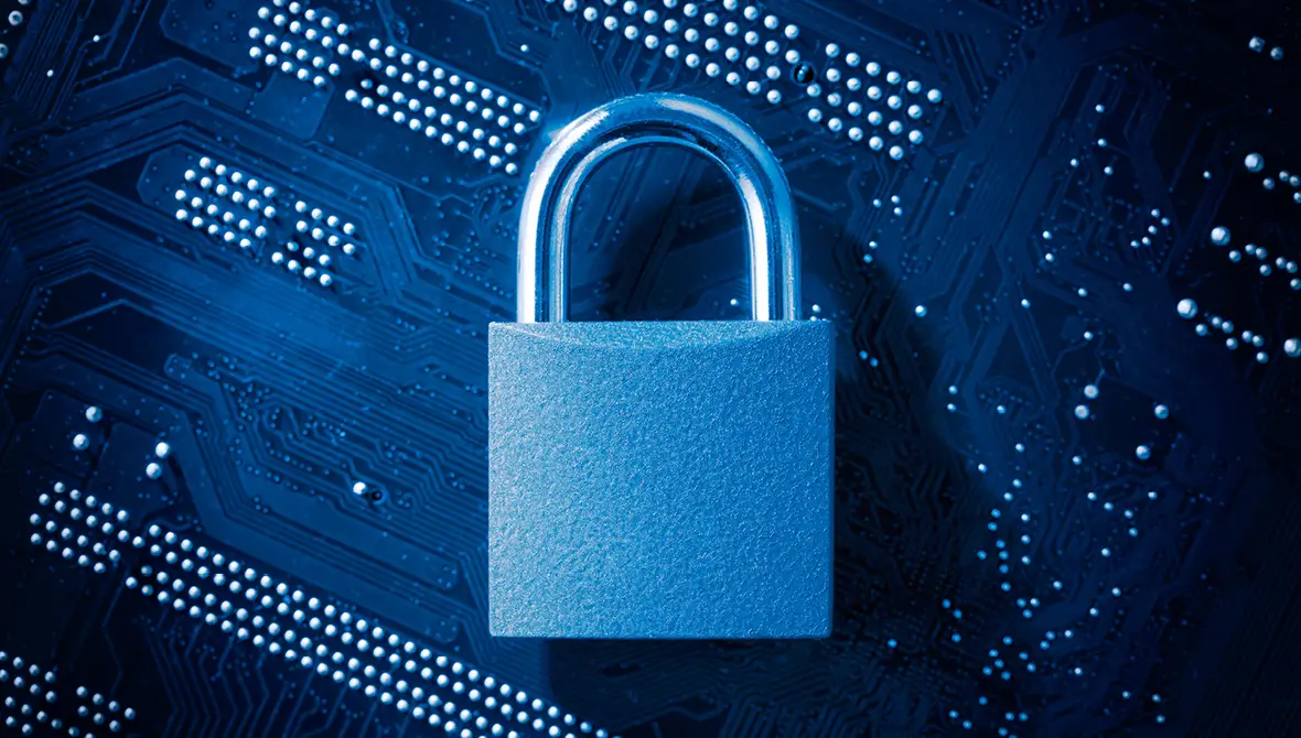 Photo of a padlock on computer motherboard, symbolizing cybersecurity