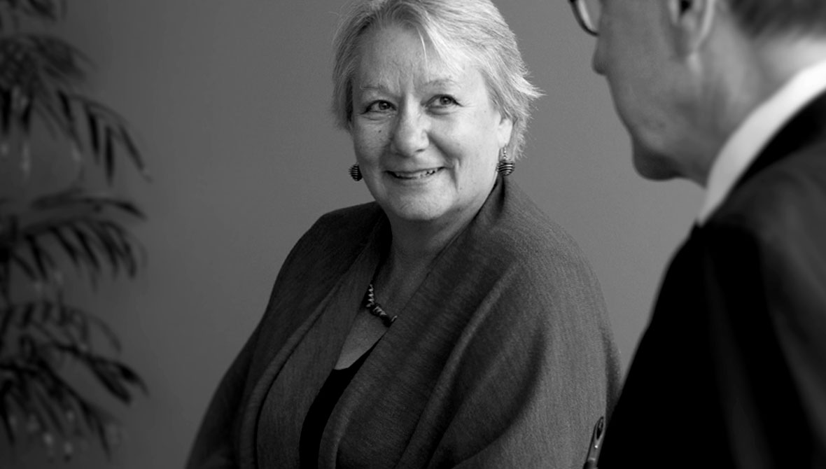 Photo of Teri Behrens smiling at a colleague