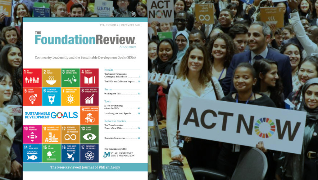 Photo background shows participants at the UN Youth Forum holding signs in support of the Act Now Sustainable Development Goals campaign (UN Photo). The cover of The Foundation Review vol. 13, issue 4 is shown on top of the photo.