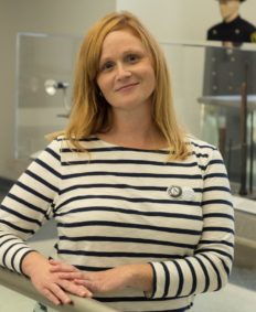 Photo of Erin Berecz, a PAARI AmeriCorps Recovery Coach. She is a white female with long, strawberry blond hair and hazel eyes. She is wearing a beige blouse with black horizontal stripes.