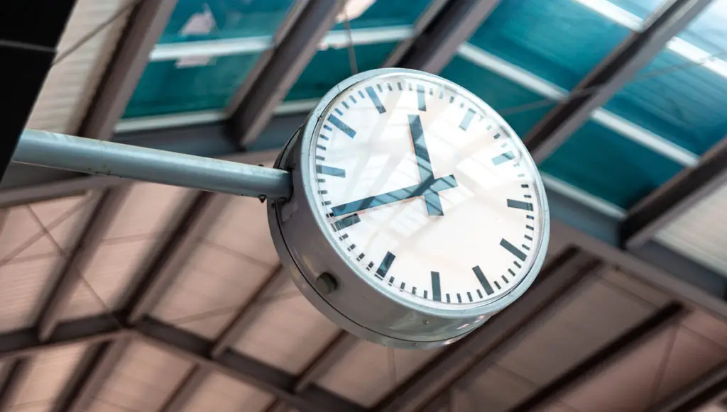 Close-up photo of a large, analog clock at a train station