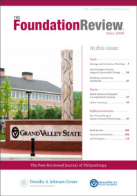 Front cover of The Foundation Review, volume 14, issue 3. The cover photo shows a new limestone sculpture called “Earth Totem” by local Anishinaabe artist Jason Quigno on Grand Valley State University's Pew Campus in downtown Grand Rapids, Mich.