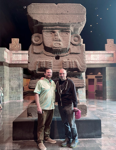 Michael Moody and Michael Layton pose in front of a large sculture at the Museo Nacional de Antropología