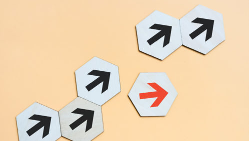 Images of a series of black arrows pointing up and to the right in a line, indicating progress, with one red arrow pointing off course. (represents maintaining focus on racial equity)