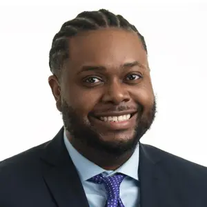 Headshot of Dr. James Bell, a Black man wearing suit