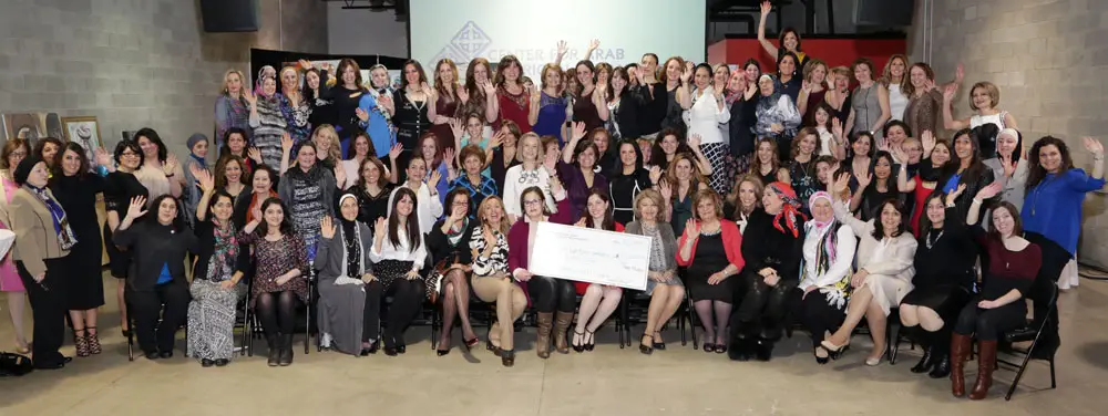 A large group of women who make up CAAP's “100 Arab American Women Who Care” giving circle