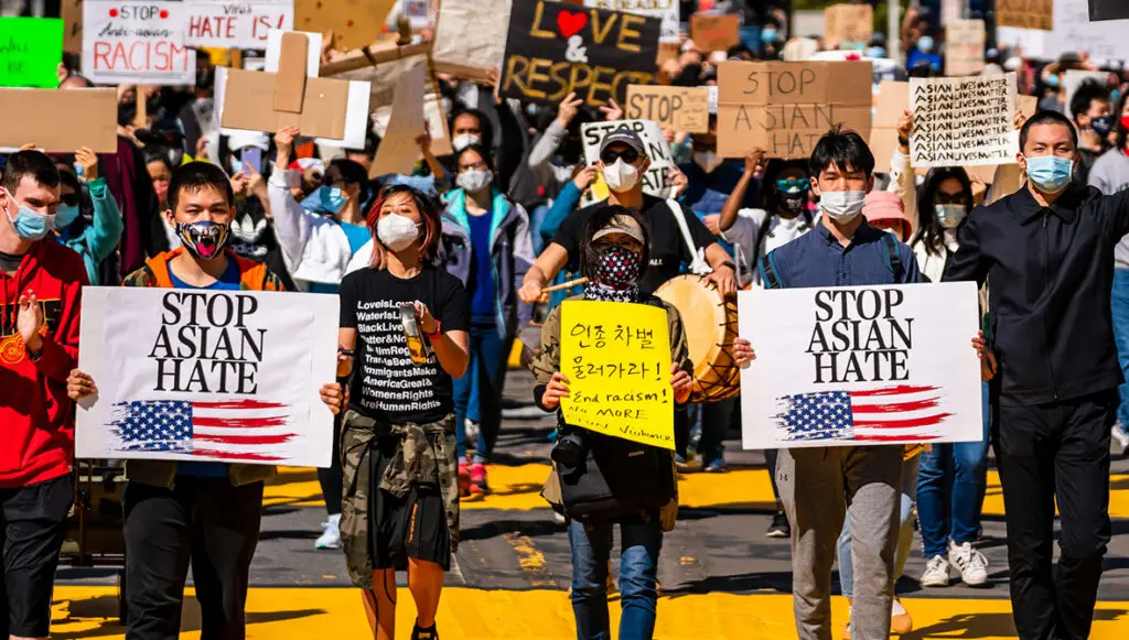 Crowd gathered around Mcphereson Square in Washington D.C., marching to Chinatown on March 12, 2021. Demonstrators hold signs that read "Stop Asian Hate" and "Asian Lives Matter."