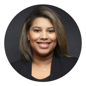 Headshot of Harmony Rhodes, a Black woman with straight, brown hair and wearing a black blouse and suit jacket.