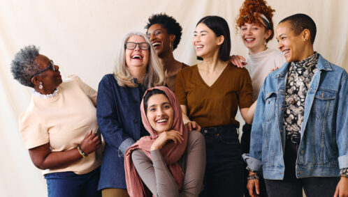 A diverse group of women smiles for the camera