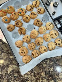 A sheet pan of freshly baked chocolate chip cookies.