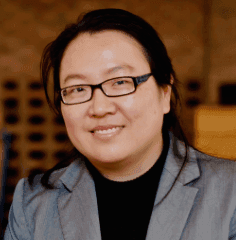 Headshot of Li Ma, a woman wearing glasses, a black turtleneck, and a gray blazer.
